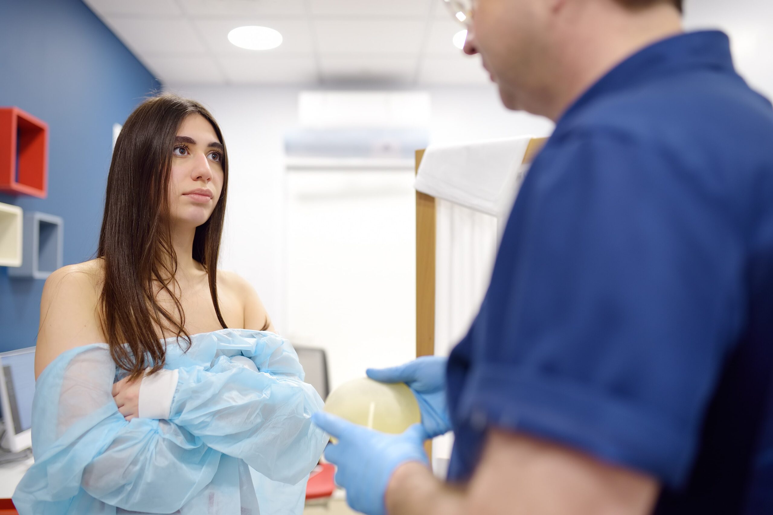 Surgeon explaining breast reduction options to female patient